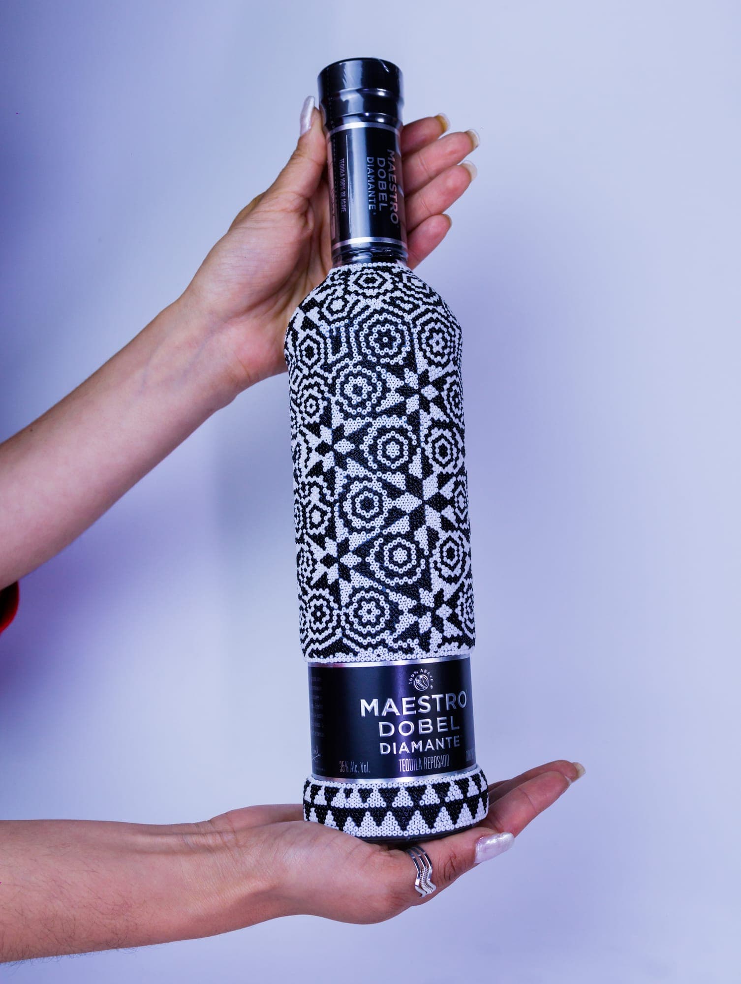 Azura Roots — hands holding the artisan bottle